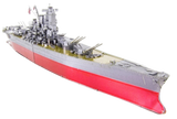 Assembled metal model of a Yamato Battleship with red hull on a white background