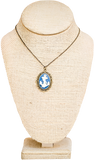 A large blue necklace with a white anchor in the center and a blue oval-shaped boarder.