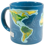 A blue mug with some countries that are green and yellow. It looks like the countries are submerged in water. There are blue, grey, and yellow arrows all around the countries.