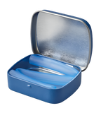 A silicone straw in a tin. The straw is blue and folded up inside the tin.