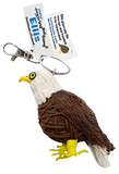 A string doll of an eagle. It has a white face, a yellow beak, black and yellow eyes, a brown body, a white feather, and yellow feet. A tag states that its names is, "Ellis."