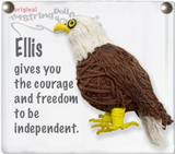 A string doll of an eagle. It has a white face, a yellow beak, black and yellow eyes, a brown body, a white feather, and yellow feet. Some text next to it reads, "Ellis gives you the courage and freedom to be independent."