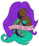 Mermaid sticker with banner reading "feeling salty" across torso. Mermaid has purple hair, green tail and black skin.