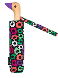 A black umbrella with flowers on it with a duck head at the top of the pole with a purple beak.