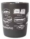 A grey mug with different food from Philadelphia. The food we can see from this angle is a pork roll sandwich, hoagies, tomato pie, cheesesteaks, and cannolis.