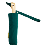 A green umbrella with a duck head at the top of the pole with a green beak.