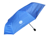 A light blue umbrella with ISM's logo which is an anchor sitting on a wave encompassed by a circle that is surrounded by stars. Underneath the logo, there is text that reads, "Independence Seaport Museum."