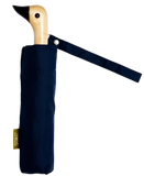 A navy blue umbrella with a duck head at the top of the pole with a navy blue beak.