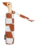 A brown and white checkered umbrella with a duck head at the top of the pole with a brown beak.