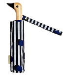 A black, white, and blue polka dotted and striped umbrella with a duck head at the top of the pole with a black beak.