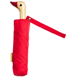A red umbrella with a duck head at the top of the pole with a red beak.