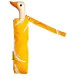 A yellow and white umbrella with a duck head at the top of the pole with an orange beak.