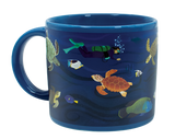 A blue mug with illustrations of sea turtles, fish, and a scuba diver in the ocean.
