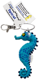 A string doll of a seahorse. It is blue with a yellow eye. A tag on it states that its name is, "Spiral."