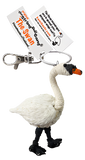 A string doll shaped like a swan. It has a white body, black legs and face, and an orange beak. A tag states that it is called, "The Swan."