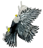 Decorative eagle hair clip with yellow accents.