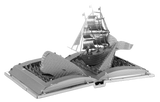 Metal model of a ship on an open book