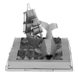 Metal model of a ship on an open book