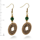 Pair of gold and jade beaded coin shaped earrings with Chinese characters inscribed with a ruler for scale on a white background