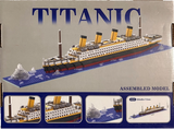 Boxed model of the Titanic with a ship on a blue base