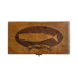 A rectangular wooden box with a hinged clasp at the bottom center, featuring an engraved dark brown whale silhouette inside a circular border and the words 'White Whale' on a banner below