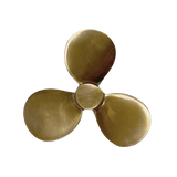 A three-blade boat propeller made of polished brass, shown from the bottom perspective