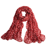 A red scarf with white anchors repeated on it. 