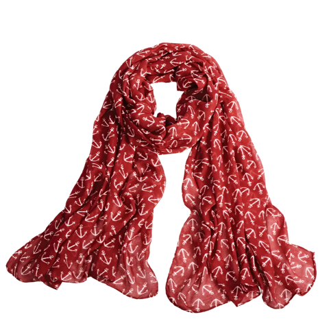 A red scarf with white anchors repeated on it. 