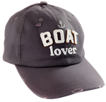 A brown hat that says "Boat lover" in the center in white fabric. There is a small anchor above the text. Parts of the hat are slightly destressed. 