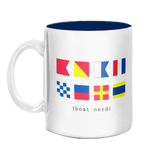 White mug with colorful signal flags and text 'boat nerd' on a white background