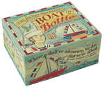 A blue box with a white and red boarder. It showcases a boat in a bottle, a green parrot, and a smug looking sailor. The top of the box reads "The secret revealed. Boat in a Bottle." On the side of the box, there shows a scene of the sailor on a red boat, holding a telescope. There is a seagull in the sky and a fish jumping out of the water. The side of the box reads "Where shall we adventure, to-day that we're afloat."