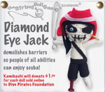 A white string doll with blacked out eyes with a single blue gem in one, a red hat, a skeletal mouth, a black strap over his white chest, black pants, and a red peg leg. He is holding a wire sword. Text on the side reads, "Diamond Eye Jack demolishes barriers so people of all abilities can enjoy scuba! Kamibashi will donate $1.00 for each doll sold online to Dive Pirates Foundation."