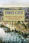 A book cover showing a city on the water with tons of houses and buildings. The water has many boats on a dock. There is text on the top that says the author's name, "Gary B. Nash." The title in the center reads, "First City. Philadelphia and the Forging of Historical Memory."