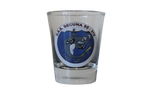 A shot glass with a depiction of the Becuna on it. The Becuna is characterized as a strong, almost shark-looking cartoon character who is withstanding torpedoes. There is text above the image that says, "U.S.S. Becuna SS - 319."