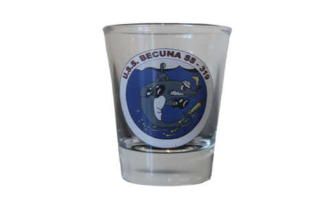 A shot glass with a depiction of the Becuna on it. The Becuna is characterized as a strong, almost shark-looking cartoon character who is withstanding torpedoes. There is text above the image that says, "U.S.S. Becuna SS - 319."