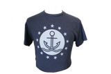 A navy-blue shirt with the ISM logo, which is an anchor sitting on a wave encompassed by a circle that is surrounded by stars.