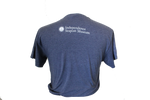 The back of a navy-blue shirt which says, "Independence Seaport Museum" on the top of it, along with ISM's logo, which is an anchor sitting on a wave encompassed by a circle that is surrounded by stars.