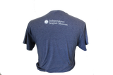 The back of a navy-blue shirt which says, "Independence Seaport Museum" on the top of it, along with ISM's logo, which is an anchor sitting on a wave encompassed by a circle that is surrounded by stars.