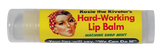 Rosie the Riveter themed lip balm. There's a picture of Rosie's face off to the side, where she has her iconic red and white polka-dotted headband on, along with pale skin and brown hair. There is text next to the face that says, "Rosie the Riveter's Hard-Working Lip Balm. Machine Shop Mint. Your lips will say, 'We Can Do It!'"