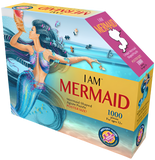 A puzzle box with text that says, "I Am Mermaid. Mermaid-shaped jigsaw puzzle. Poster size! 1000 pieces. For ages 12+." There is a picture of a mermaid on the side of the box with puzzle pieces coming out of her. She is holding a shell next to her head.