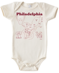 A white onesie that has illustrations of a map of Philadelphia and some Philadelphia-specific iconography, like the Liberty Bell, Rocky, and the Love sign. There is text on the top of the onesie that says, "Philadelphia." 