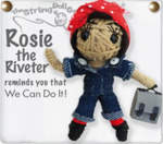 A Rosie the Riveter string doll. She has tan skin, a red and white polka-dotted headband, a blue jumpsuit with a grey undershirt, red socks, and black boots. There is text next to her that says, "Rosie the Riveter reminds you that We Can Do It!" 