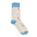 A pair of crew socks with a beige body featuring a nautical print of sailboats, lighthouses, and seagulls, accented with light blue cuffs, heels, and toes.