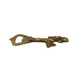 Brass fish bottle opener shown from the side