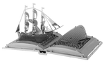 Metal model of a ship on an open book 