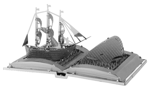 Metal model of a ship on an open book 