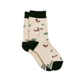 A pair of beige crew socks with dark green cuffs, heels, and soles, featuring a pattern of ducks and reeds