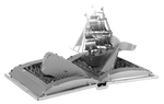 Metal model of a ship on an open book 