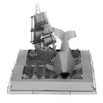 Metal model of a ship on an open book 